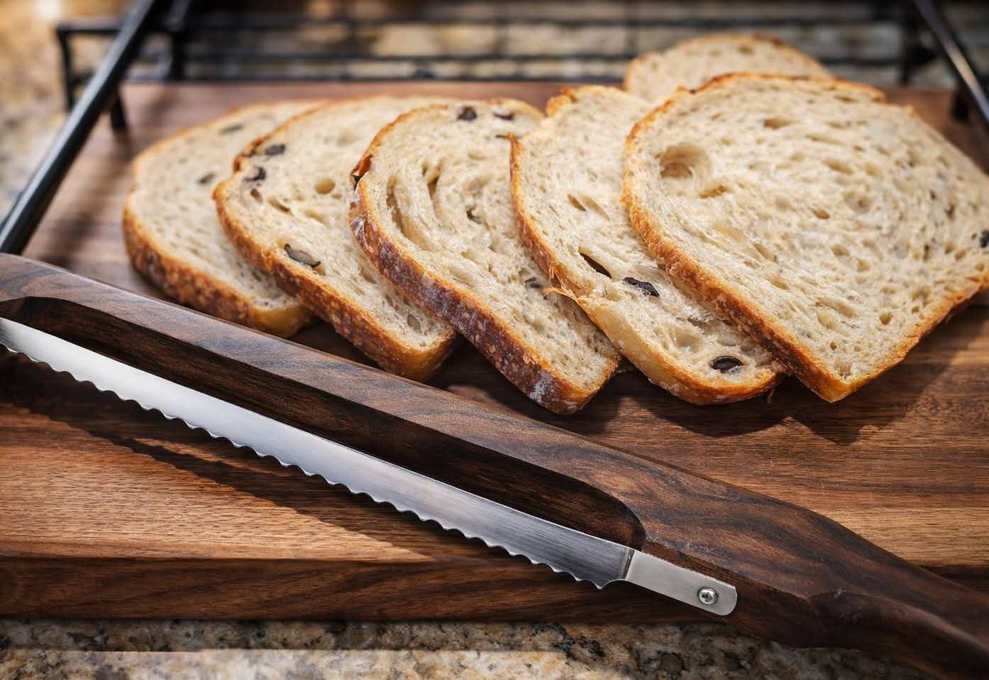 Sliced sourdough loaf on a wooden board with bread knife